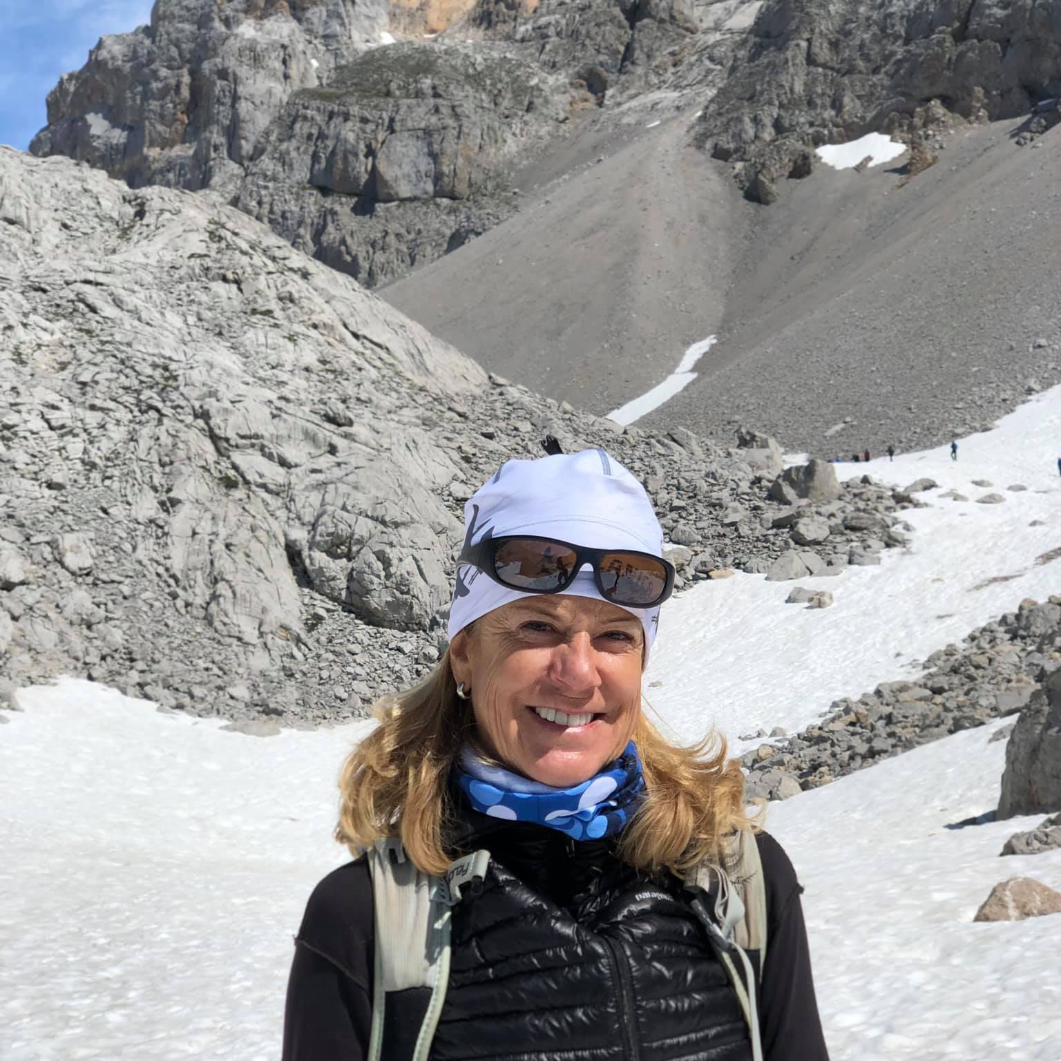 Kathy Dragon smiling on a snowy mountain trail in the Picos de Europa